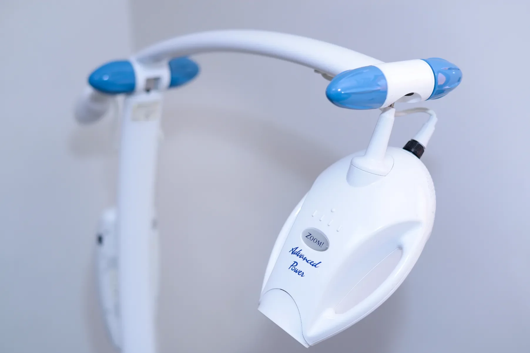 A close-up photograph of a professional Philips Zoom! Advanced Power teeth whitening lamp in a dental clinic.