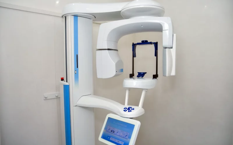 A photograph of the Planmeca ProMax 3D Classic digital imaging unit installed in a clean clinical room.
